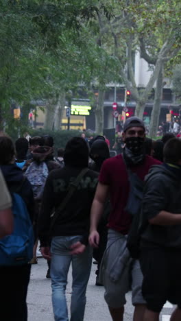 barcelona - spain - october 18 2019 : riot police clash with protestors at the general strike in via laietana, barcelona in vertical