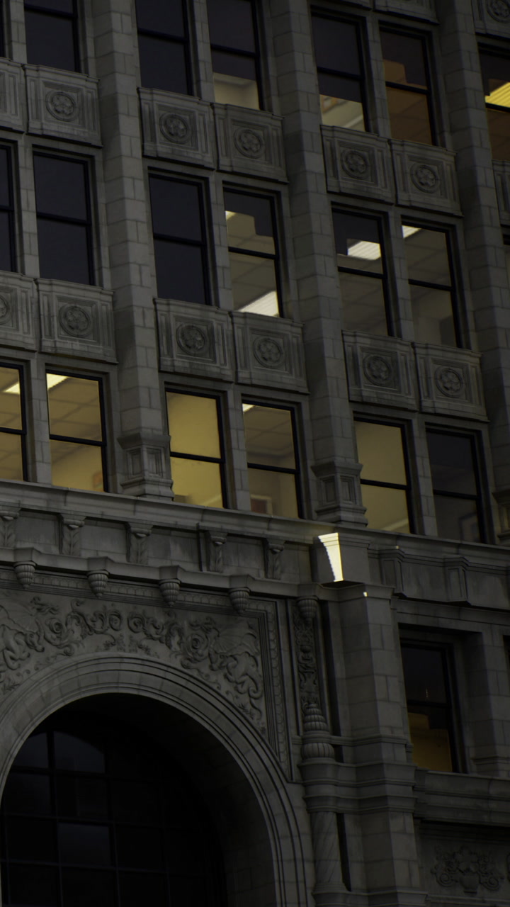 Bright windows cast a warm glow on classic architecture during dusk