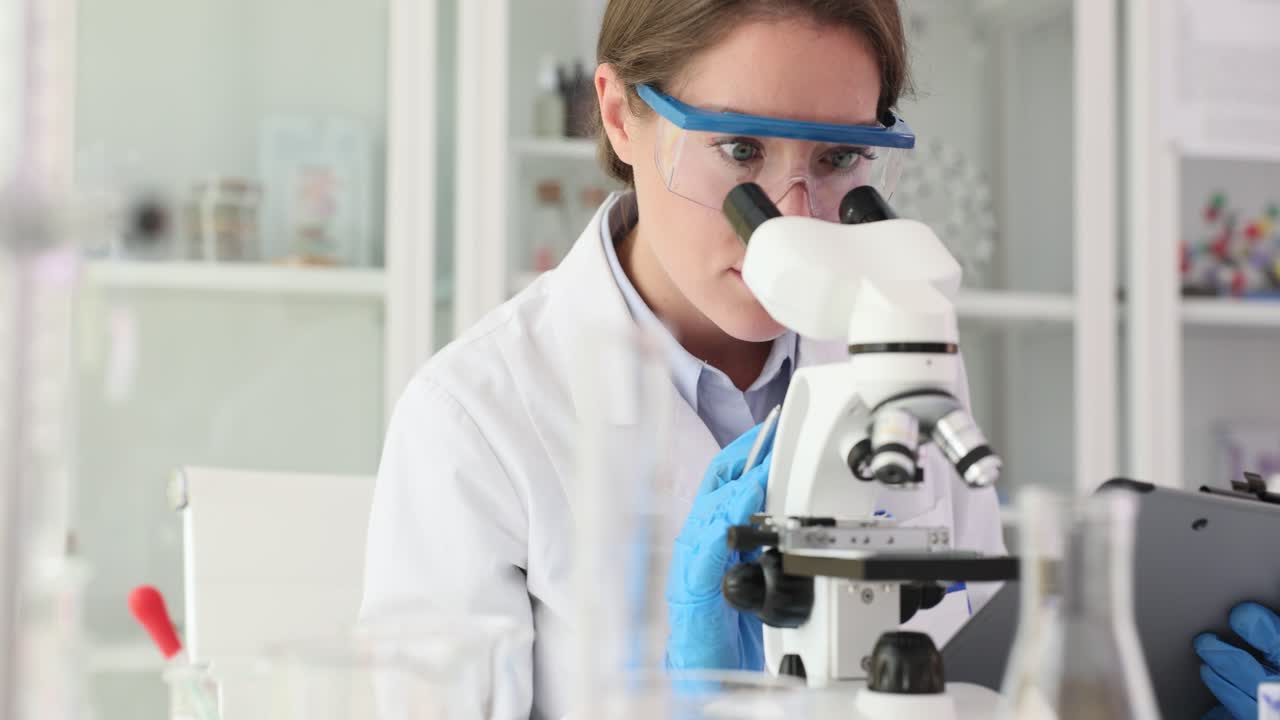 A scientist uses a microscope in a laboratory