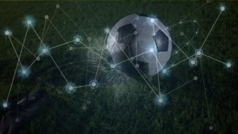 Animation-of-network-of-connections-with-icons-over-football-player-kicking-ball-on-pitch