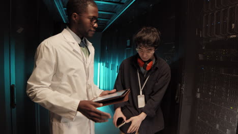 manager checking work of it engineer
