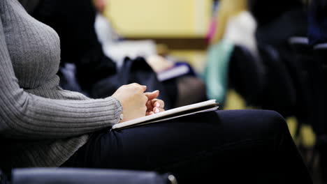 woman holding notepad. close up of girl hands holding a blank notebook