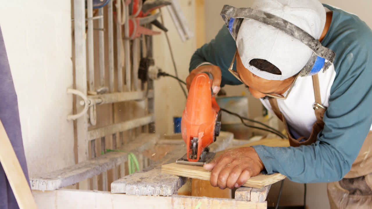 Premium stock video - Surfboard maker using machine on wooden plank 4k