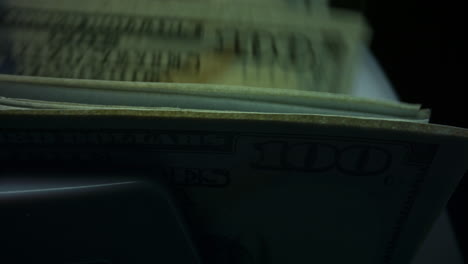 Closeup-counting-us-dollar-banknotes-on-currency-counter-machine