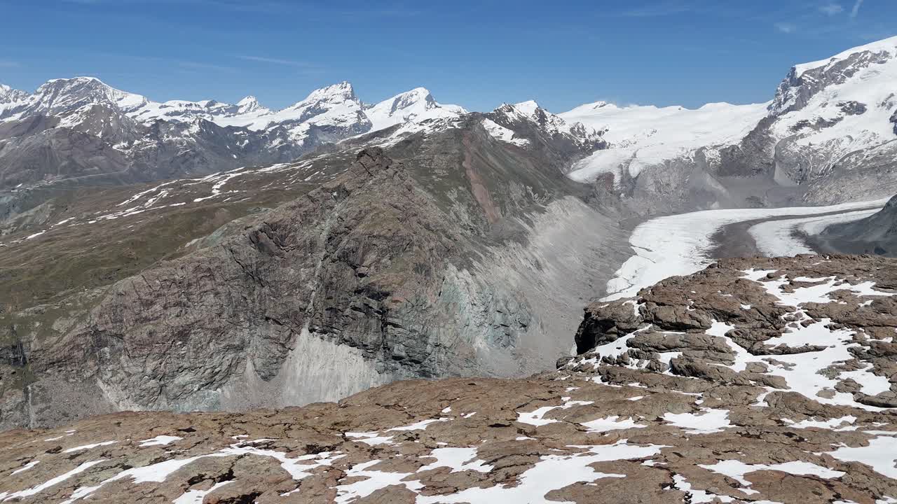 Approaching liff edge over deep Swiss Alps breathtaking aerial mountain view