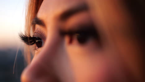 a beautiful young woman's eyes viewing the sunset