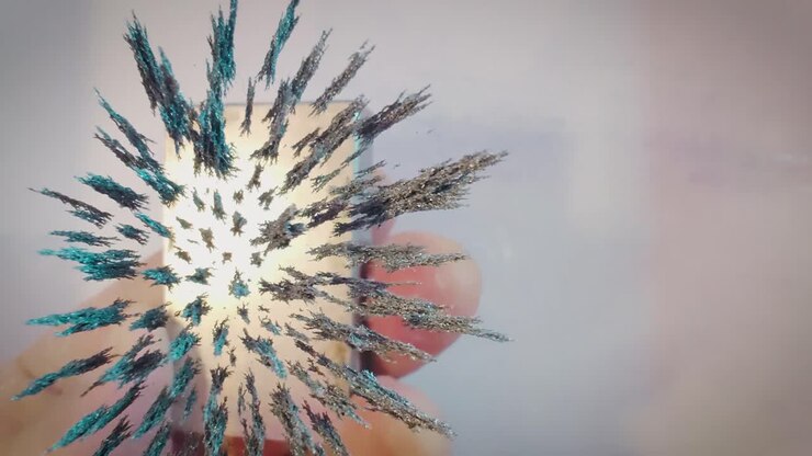 Jernspåner, der bevæger sig i magnetfeltet af en neodymmagnet, optagelse fra oven