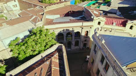 Aerial-view-dolly-in-of-the-giant-and-eclectic-style-houses-of-Barrio-Concha-y-Toro,-heritage-district-of-Santiago-Chile