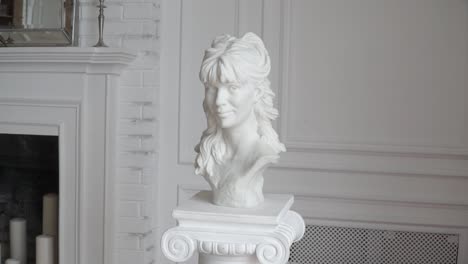 white marble bust of a woman in a living room