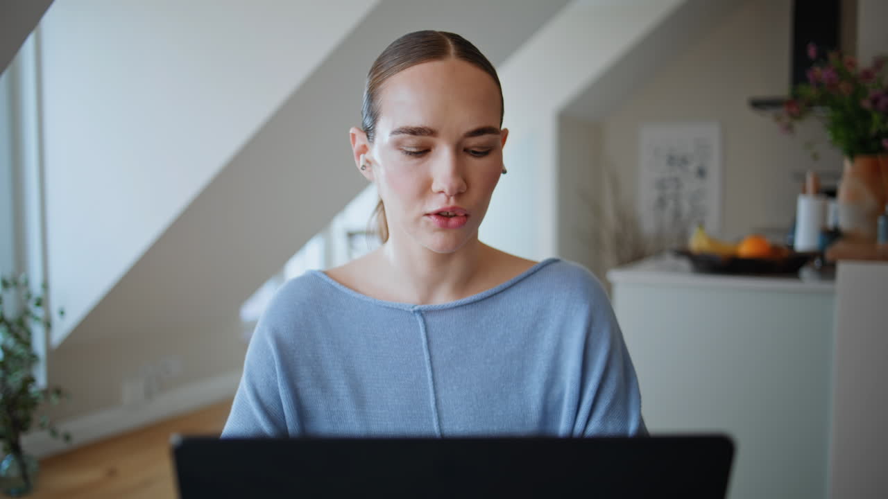 Online tutor talking laptop webcam home workplace closeup. Woman video calling