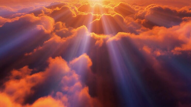 Aerial View of Golden Sunlight Streaming Through Clouds
