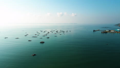 aerial-footage-of-fisherman-wooden-traditional-Indonesian-boat-in-ocean-open-water-with-golden-hours-light-in-Lombok-island