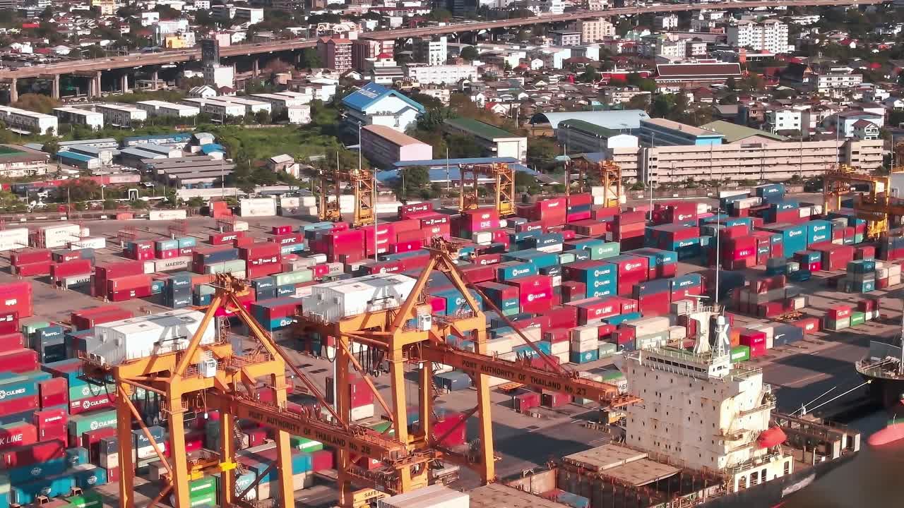 Busy shipping port in Bangkok with containers and city skyline