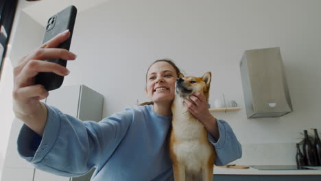 beautiful girl takes a selfie with her dog at home 1