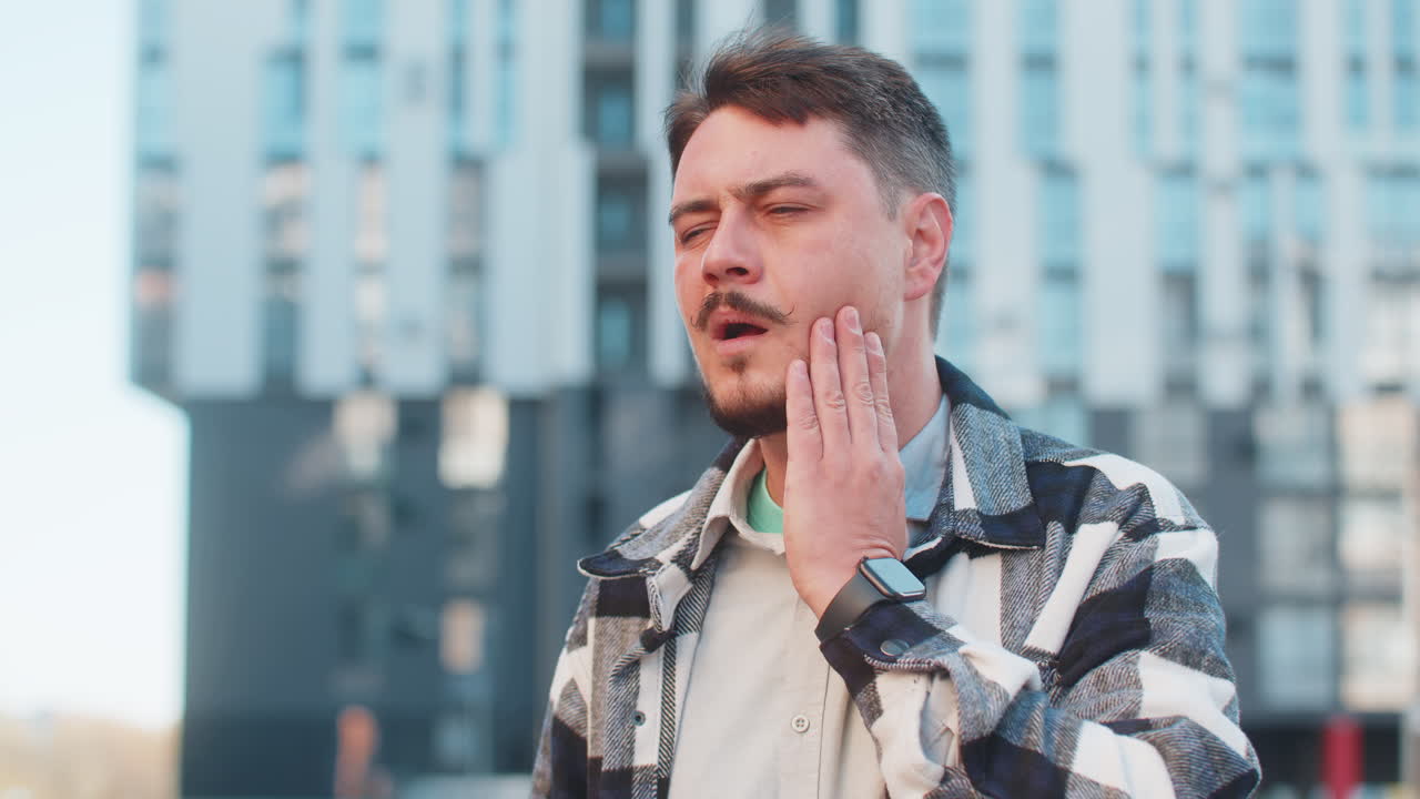 Mature caucasian businessman feeling toothache bad unpleasant symptoms suffering from pain outdoors