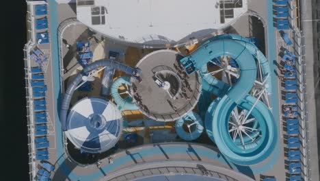 wide aerial top down of waterslides on the top of a cruise ship