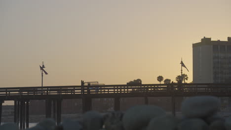 time lapse shot of people walking across the ventura pier at sunset located in ventura county southern california