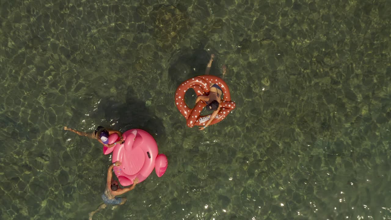 People having fun in the water with inflatable floaties