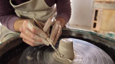 male potter making pot