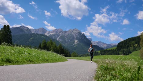 woman jogging outdoors. italy dolomites alps