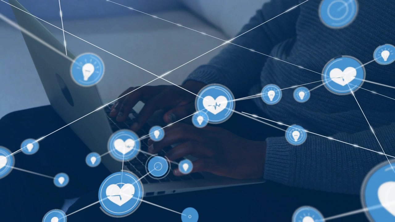 Woman typing on sofa, blue heart icon appearing on keys and growing health network overlaying hands