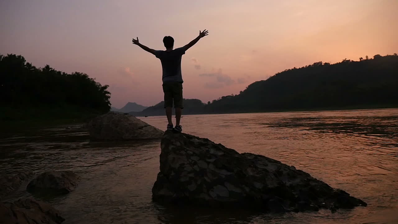 Man enjoying a beautiful sunset by the river
