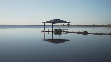 Gimbal-slomo-shot-of-wooden-gazebo-on-river,-Pilcomayo-National-Park