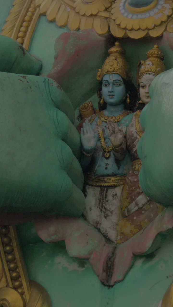 Intricate Hindu Deities Revealed by Giant Green Statue Hand