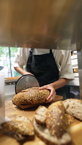 baker slicing freshly baked bread