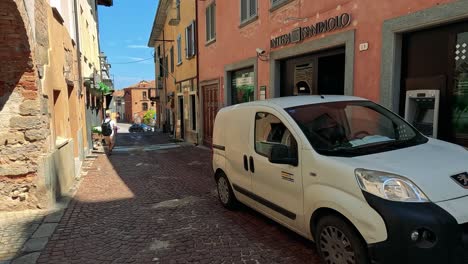 a quiet street with pedestrians and a van