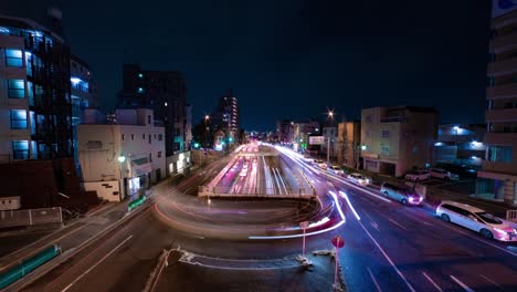 a night timelapse of the traffic jam at the city street in tokyo wide shot