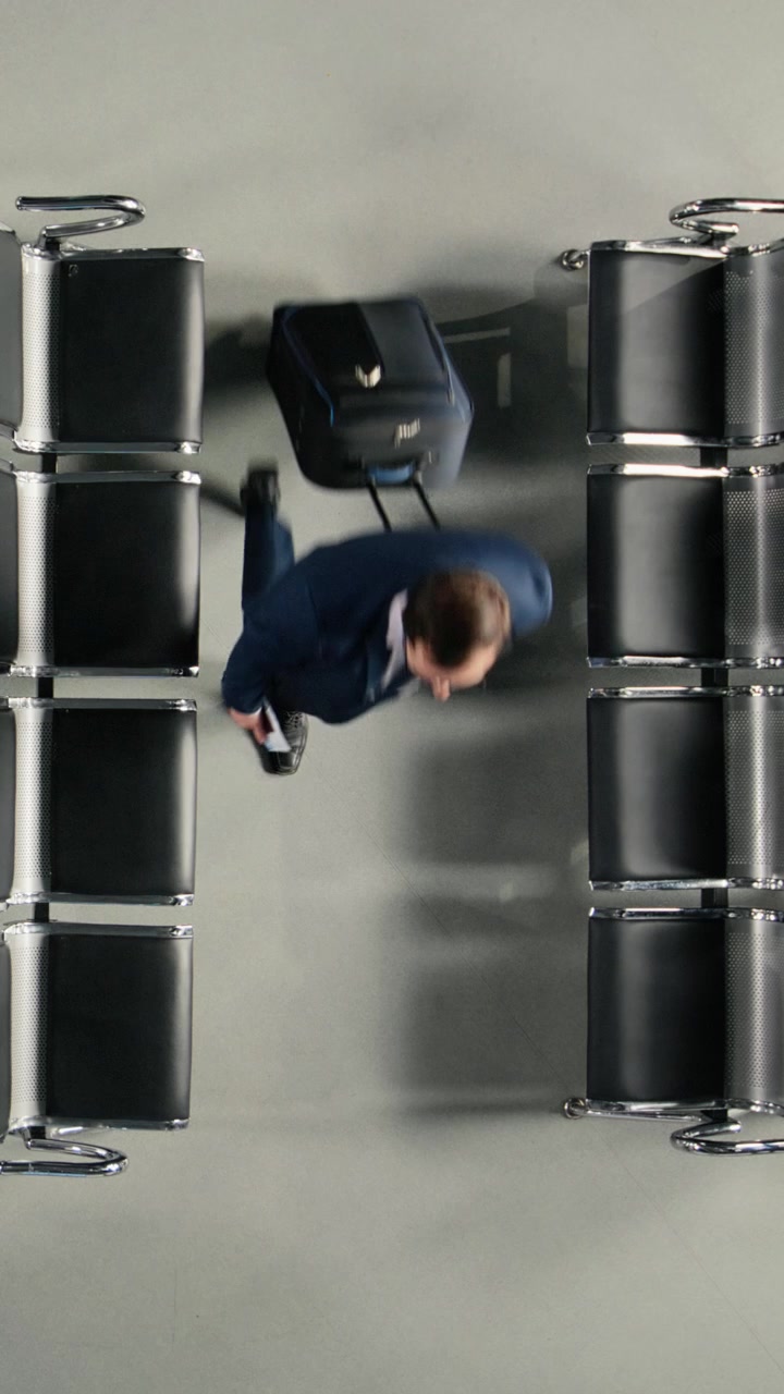 Overhead Shot of Travelers Moving Through an Airport Terminal