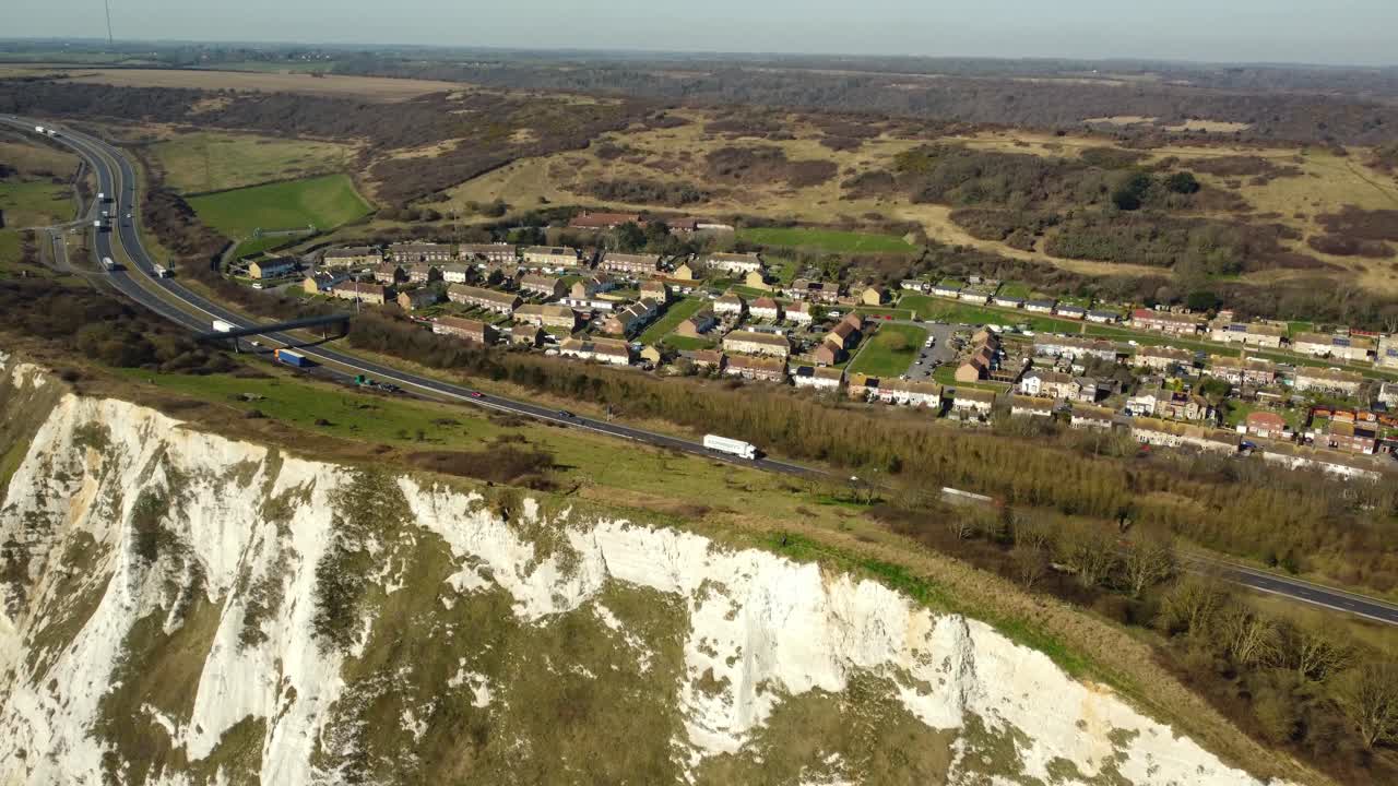 Aerial view of the White Cliffs of Dover with a village and highway