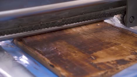 automatic process of cutting sweet nougat by machine. production of chocolates at a confectionery factory