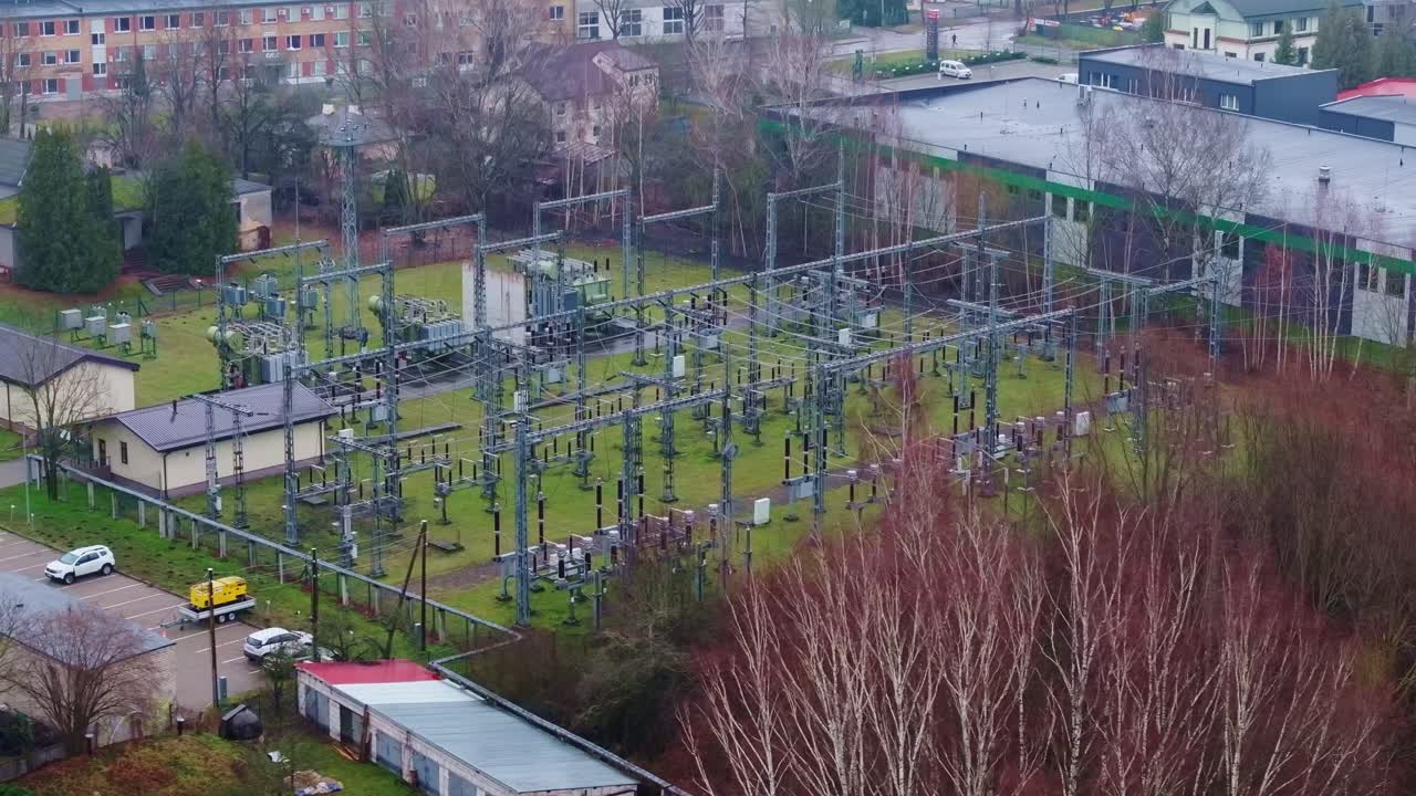 Overhead drone of electric substation in Riga surrounded by buildings and trees