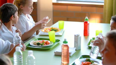 kids having meal in cafeteria