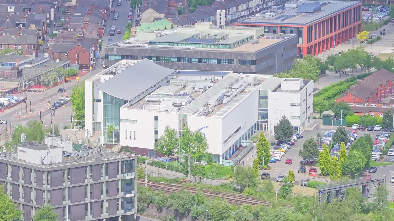 Aerial view of Sixth Form College in Stoke-on-Trent, England, on a bright sunny day, showcasing modern campus, vibrant and educational atmosphere
