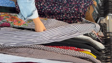 used clothes vintage fashion at a flea market side view of young woman shopping in thrift store used clothes vintage fashion at a flea market side view of young woman shopping in thrift store a customer in a vintage store