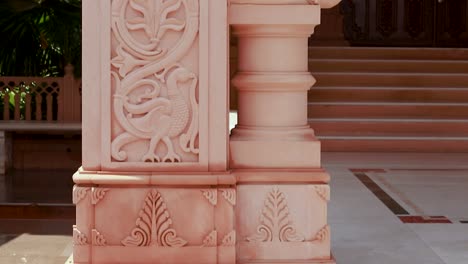 artistic-hand-carved-red-stone-jain-temple-at-morning-from-unique-angle-video-is-taken-at-Shri-Digamber-Jain-Gyanoday-Tirth-Kshetra,-Nareli-Jain-Mandir,-Ajmer,-Rajasthan,-India