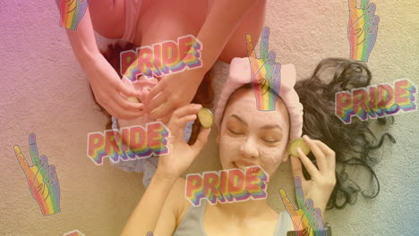 pride text and peace hand signs animation over women enjoying spa treatment