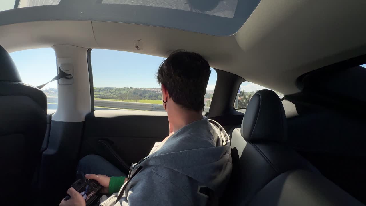 Person in backseat of Tesla Model 3