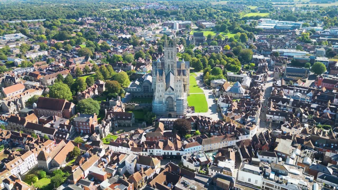 Smooth receding aerial movement from the medieval Canterbury cathedral entrance side, Kent, England.