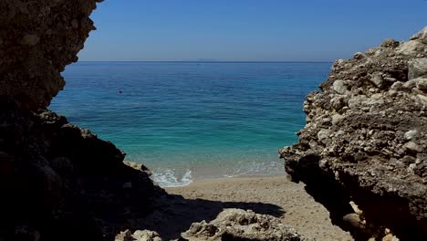 peaceful seaside with blue turquoise sea seen through cliffs and sand beach, beautiful spot for summer holiday in mediterranean