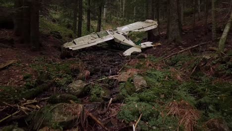 drone dolley shot over a crashed airplane in a dense forest in rhone alpes region in france