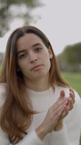 portrait of a thoughtful young woman outdoors