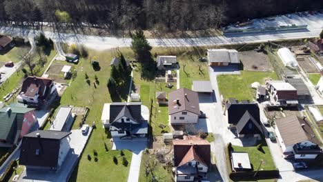 Fly-over-settlement-of-single-family-houses-on-sunny-day,-Lasko,-Slovenia