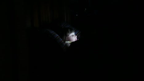 Young-Girl-using-a-tablet-in-the-dark