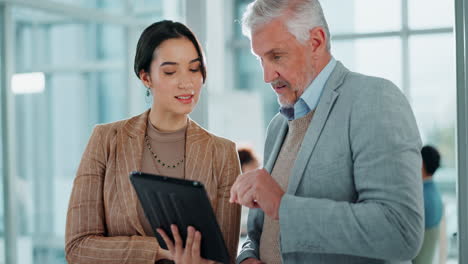 business colleagues discussing work on tablet
