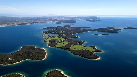 flight over desert islands and colorful sea, brijuni park, croatia. original untouched log format.