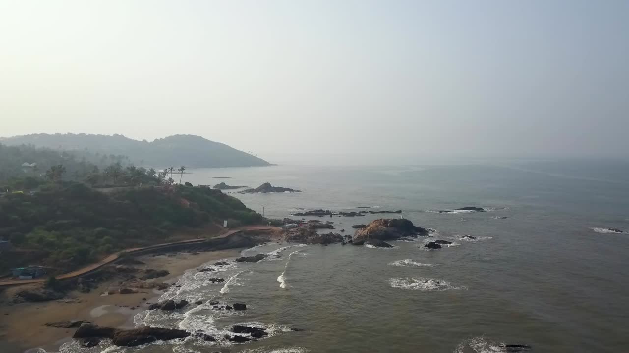 Drone shot flying towards the sun and landscape in Goa, India